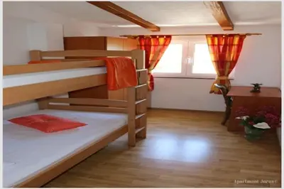Krevet ili kreveti u jedinici u objektu Apartments Juras - Two Bedroom Apartment with Sea View David