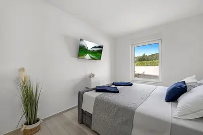 Krevet ili kreveti u jedinici u objektu Apartment Maslina mit privatem Salzwasserpool