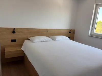 Krevet ili kreveti u jedinici u objektu Family Apartment with Breathtaking Sea & Island Views