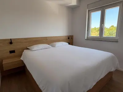 Krevet ili kreveti u jedinici u objektu Family Apartment with Breathtaking Sea & Island Views