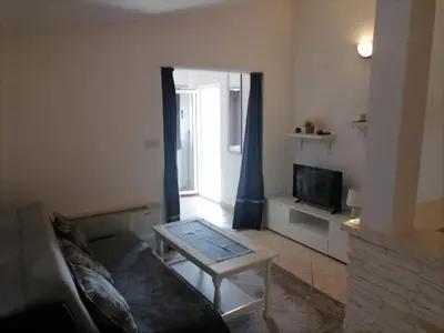 TV i/ili zabavni centar u objektu Apartments Libertas - Two Bedroom Apartment with with Terrace and Sea View 12