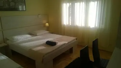 Krevet ili kreveti u jedinici u objektu Rooms & Apartments Blue Beach