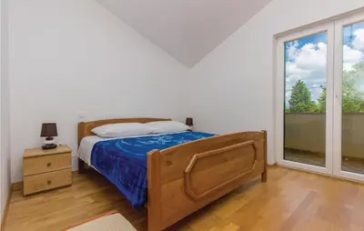 Krevet ili kreveti u jedinici u objektu Four-Bedroom Holiday Home In Miljevci