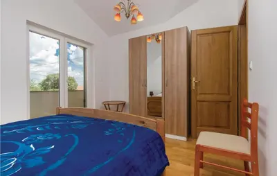 Krevet ili kreveti u jedinici u objektu Four-Bedroom Holiday Home In Miljevci