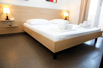 Krevet ili kreveti u jedinici u objektu Apartments and Rooms Plaza